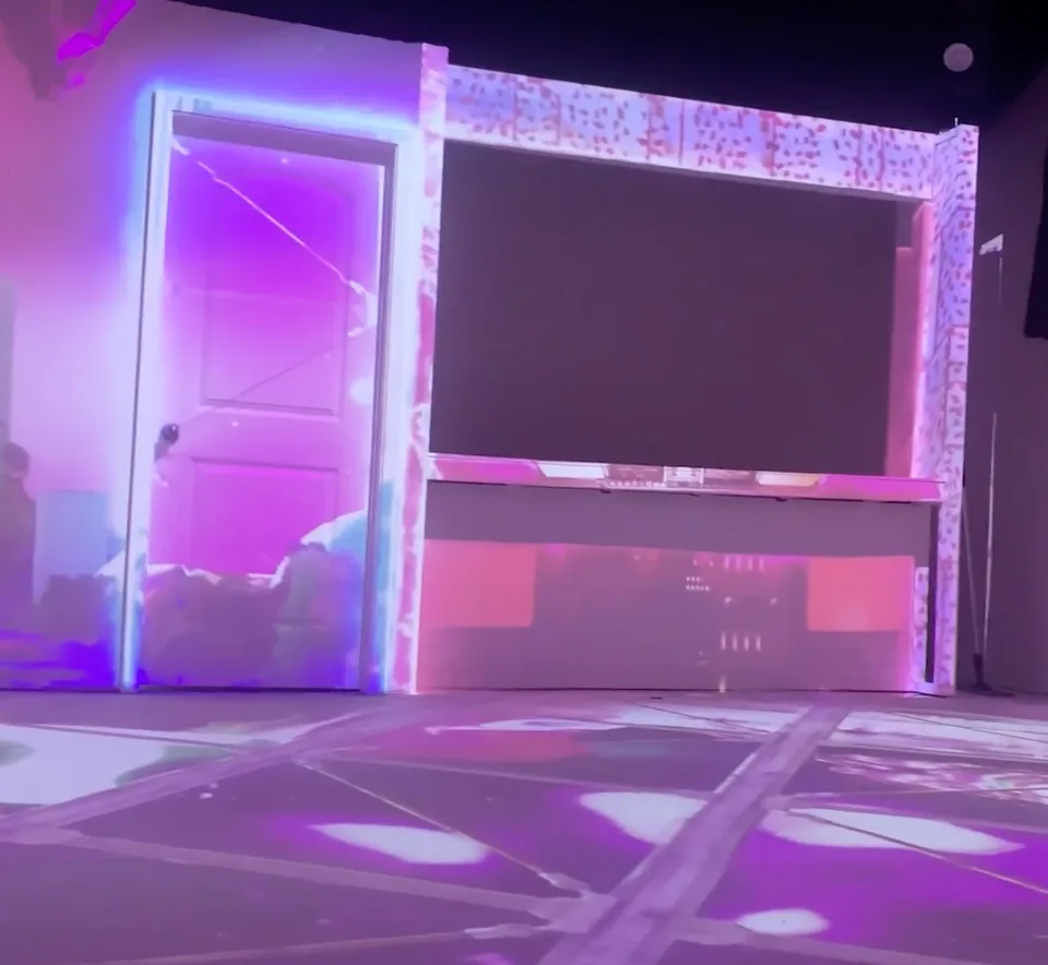 An immersive room filled with violet projection